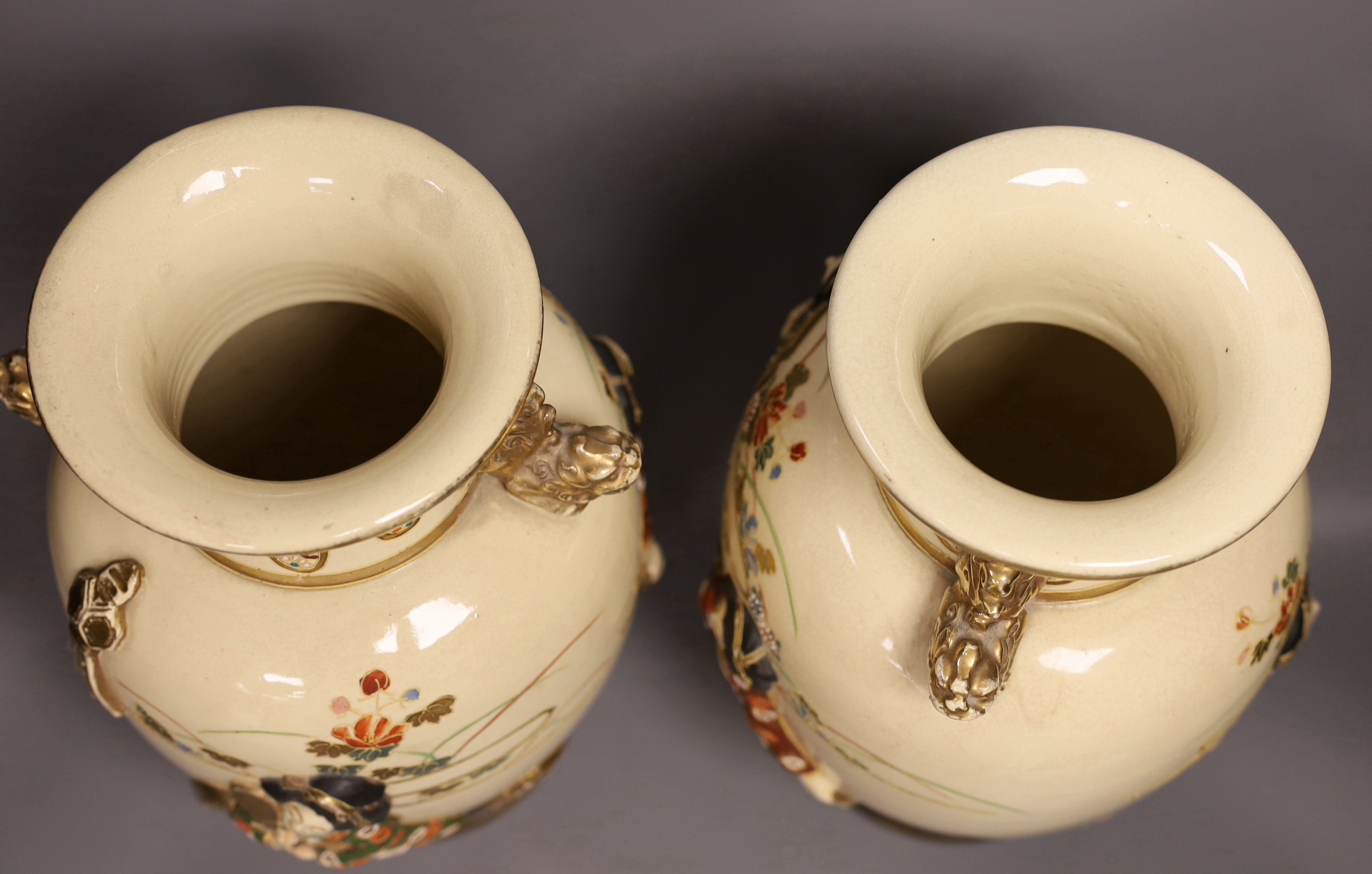 A pair of large Satsuma vases with relief decoration and dragon handles, 35cm tall with bases